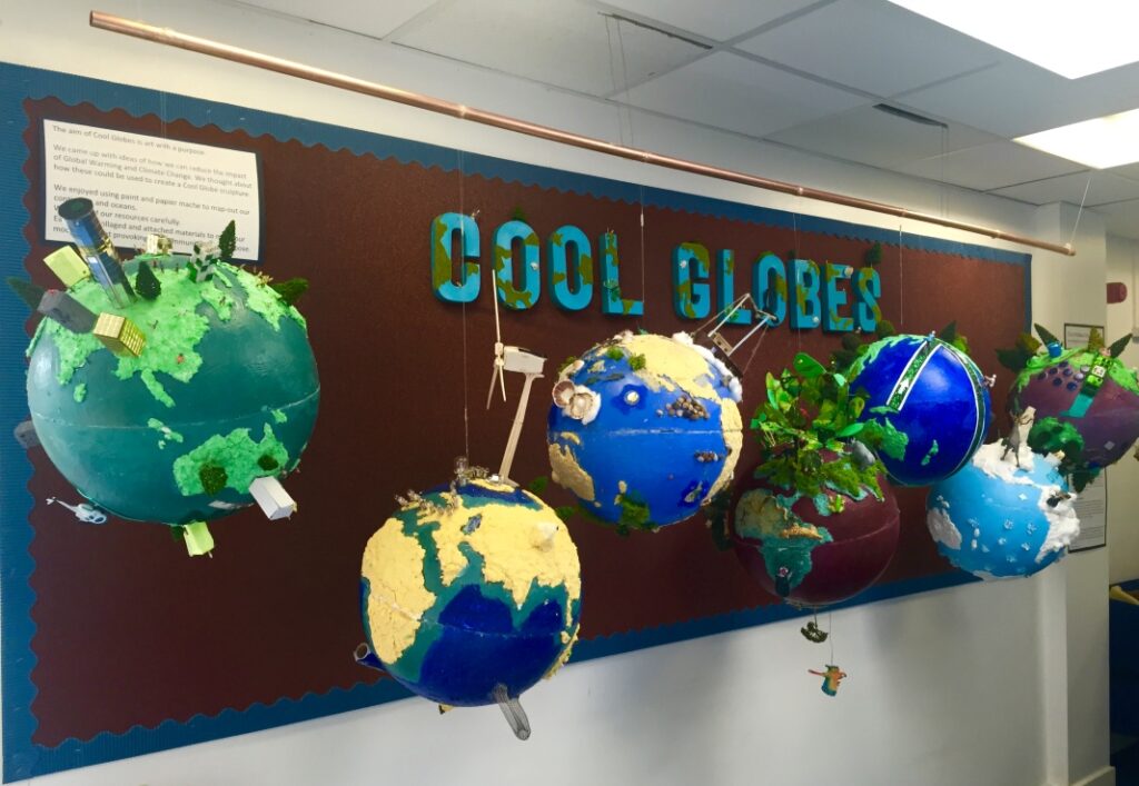 Several globes hanging in a classroom.