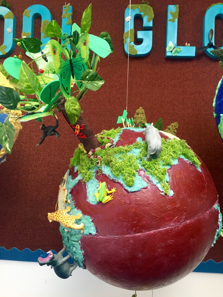 A globe with a tree atop it.