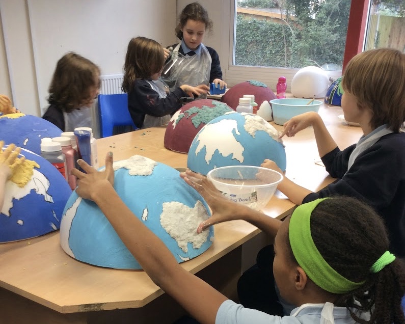 Children decorating globes.