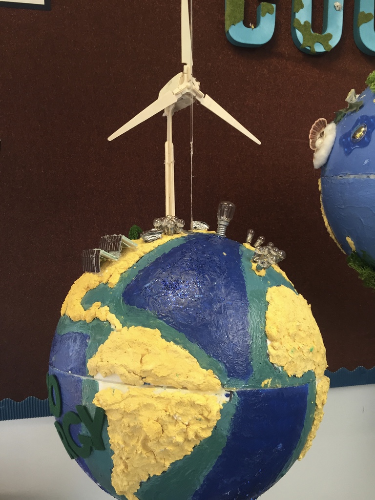 A globe with a wind turbine atop it.